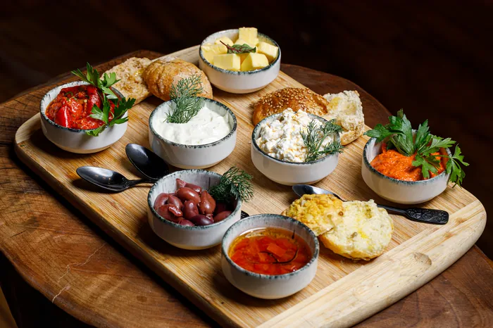 A board of homemade spreads, farm cheeses and cornbread